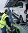 Renault Trucks driver attaching cars to be transported on a trailer